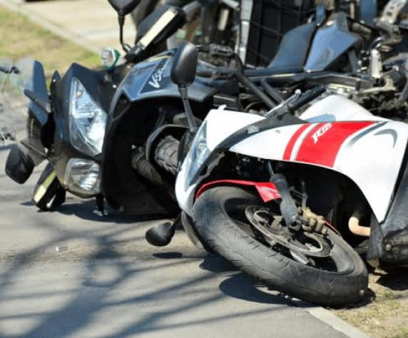 Two motorcycles on the ground.